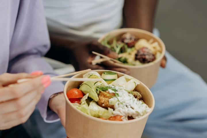 a person sitting at a table with a plate of food